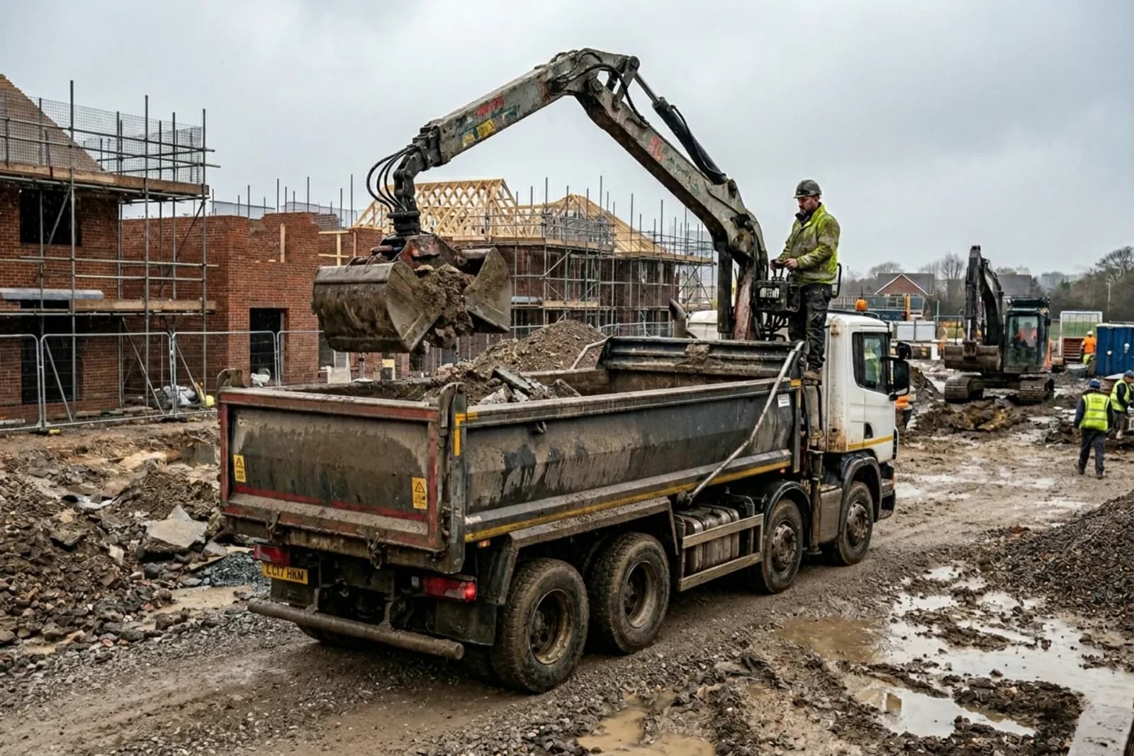 Grab lorry working at a housing-project construction site, hired through Skyward Skip Hire